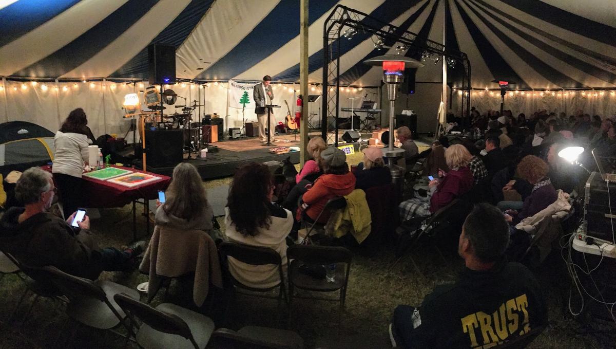 A packed tent meeting hosted by The Well of Nashville